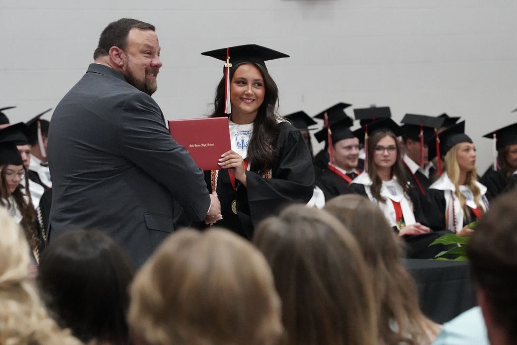 Oak Grove High School's principal presents a student with a diploma during the Oak Grove High School graduation ceremony.