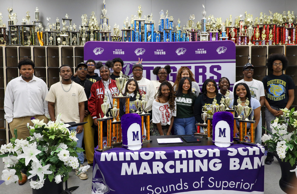 A group of band students take a group photo as they celebrate earning $3.5 million in total scholarships. 