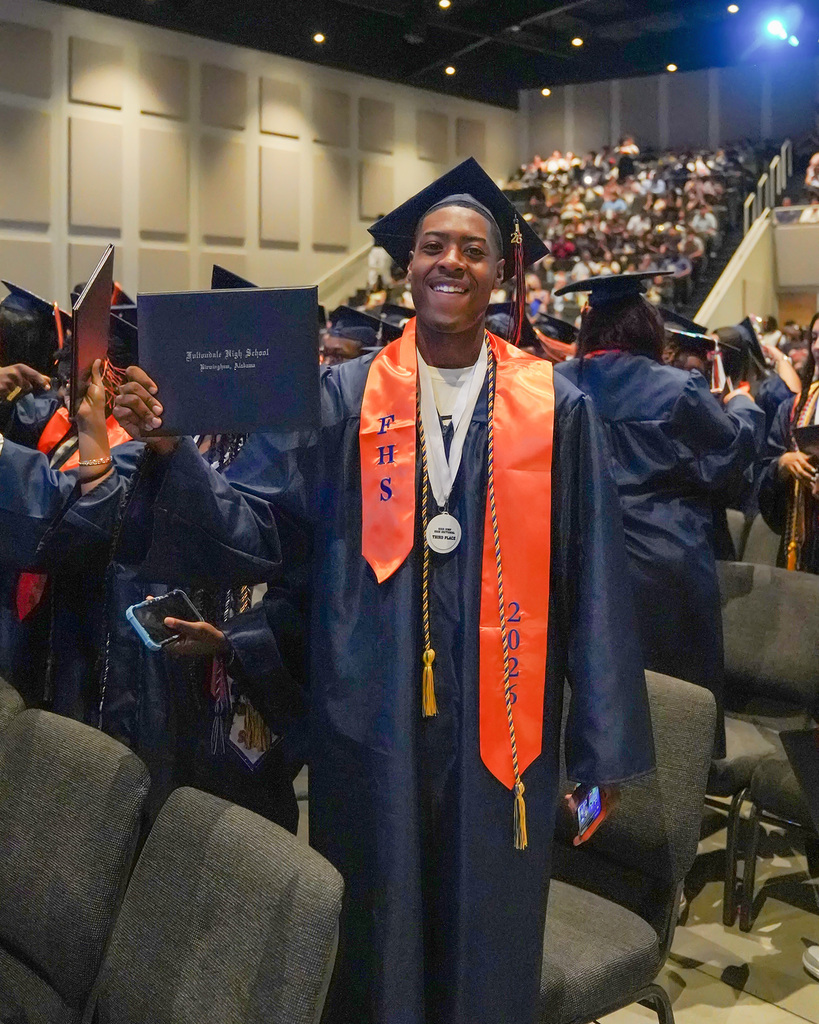 A student holds out his diploma following the 2026 Fultondale High School Graduation.