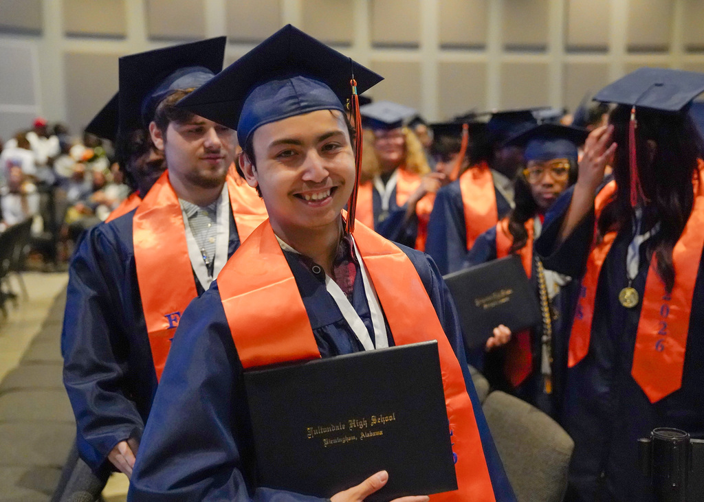 A Fultondale High School graduate holds up his diploma.