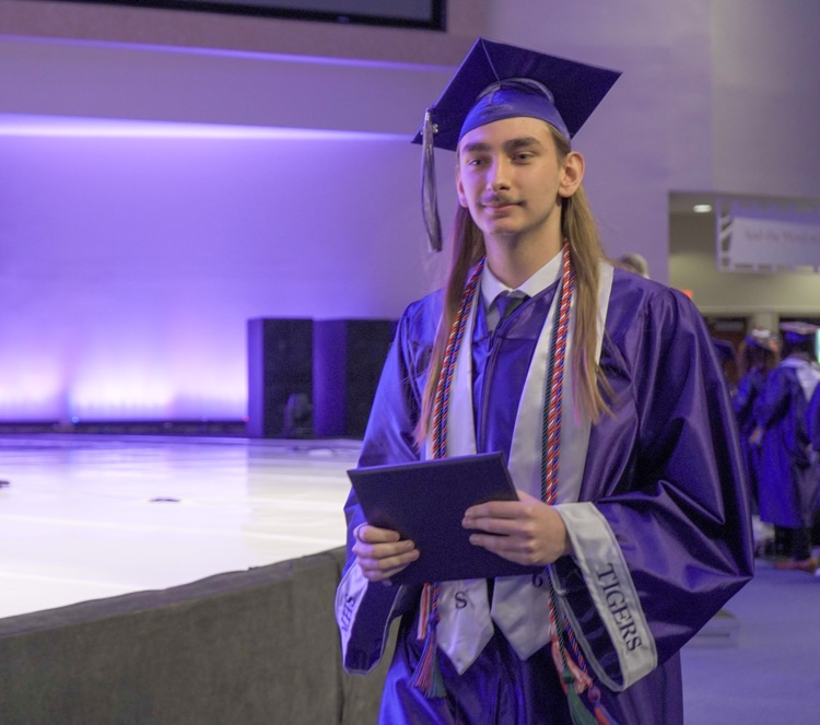 A Minor High School graduate walks through the auditorium during the school’s graduation ceremony