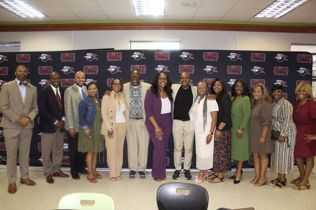 Shades Valley High School principal Taki Sarhaan poses for a photo inside a room with various educational leaders from throughout JEFCOED.