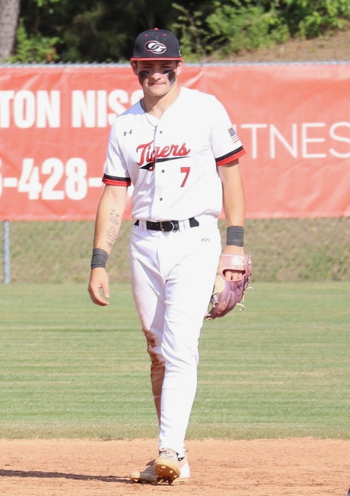 Dalton Troncalli, Oak Grove High School baseball player walks on the field during a game. He wears an Oak Grove baseball uniform.
