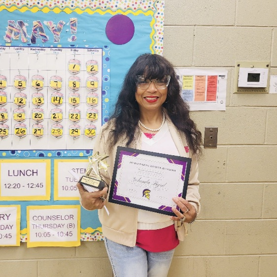 A picture of Mrs. Byrd, an outstanding substitute, holding her award.