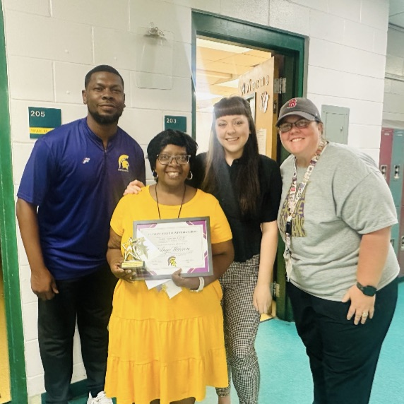 A picture of Mrs. Warren, an outstanding substitute, holding her award