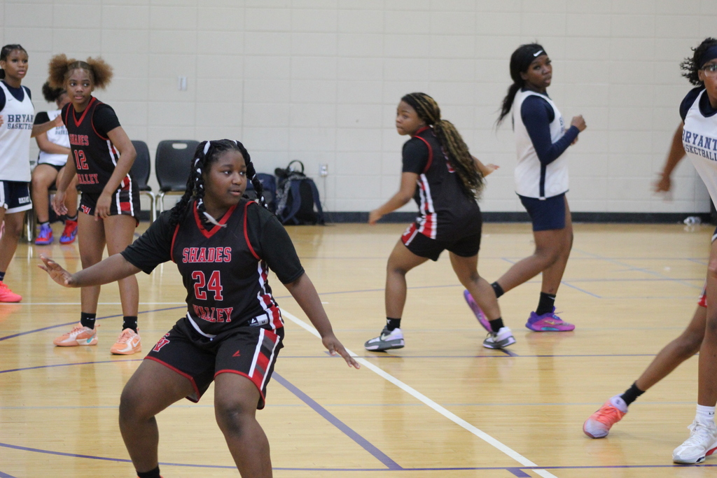 Shades Valley and Bryant girls basketball teams face off on the basketball court.