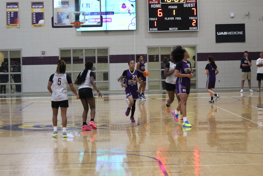 A Hueytown High School girls basketball player runs down the court during a game.