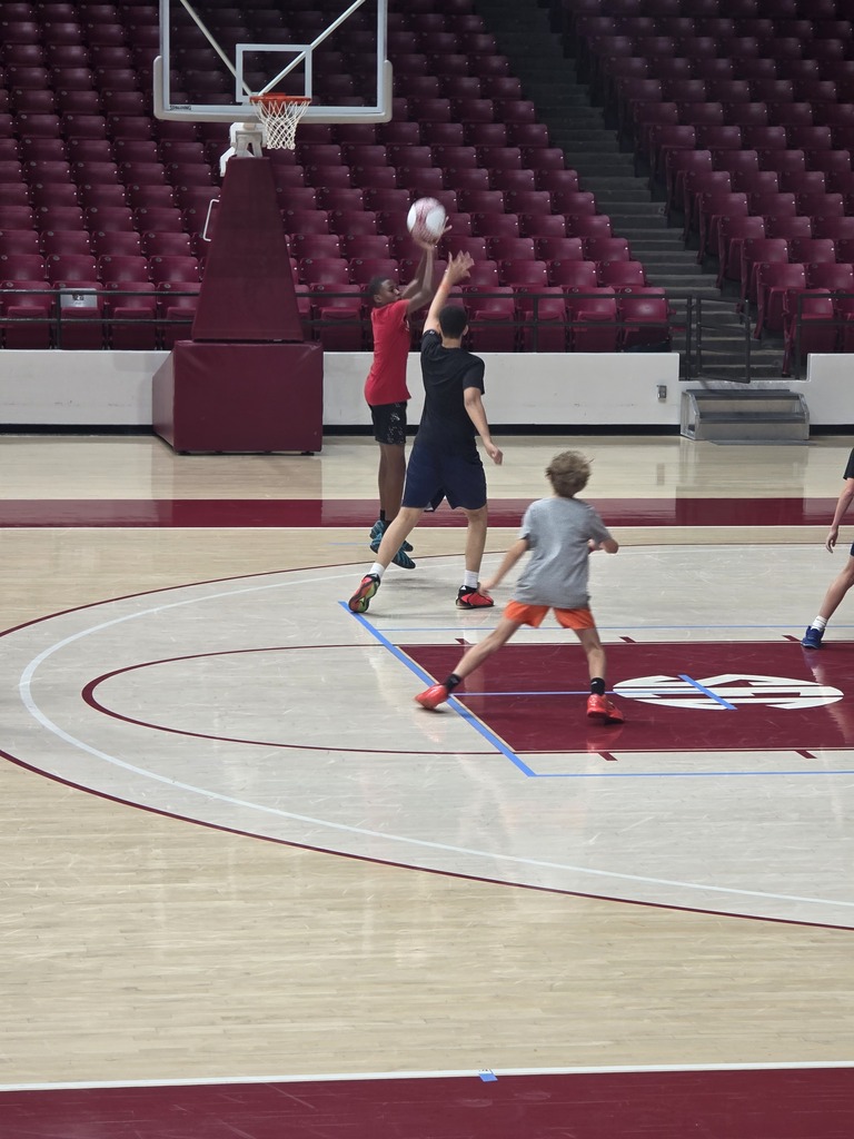 Students play basketball on a court at the University of Alabama.