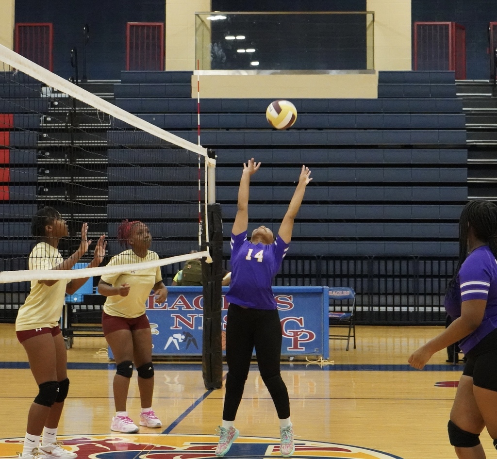 A Pleasant Grove High School volleyball player sets the ball during a game.