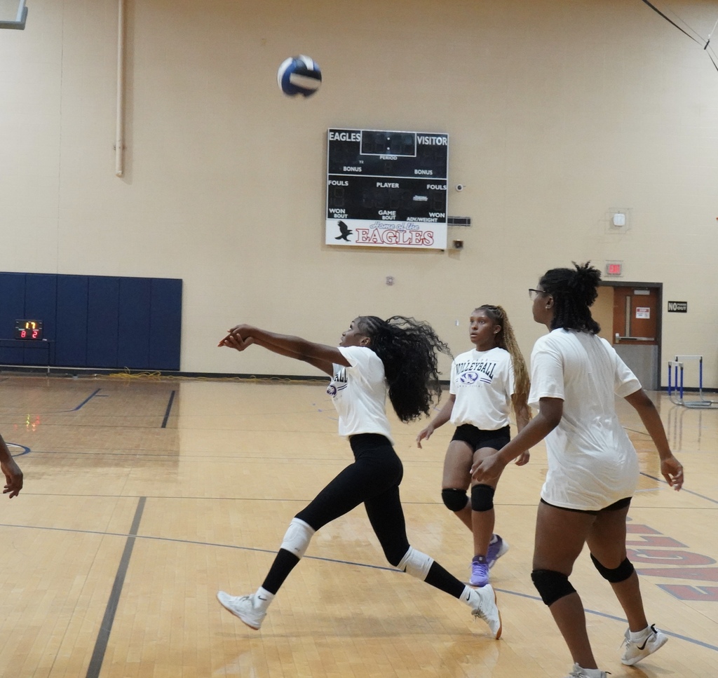 A Minor High School volleyball player passes the ball during a game.