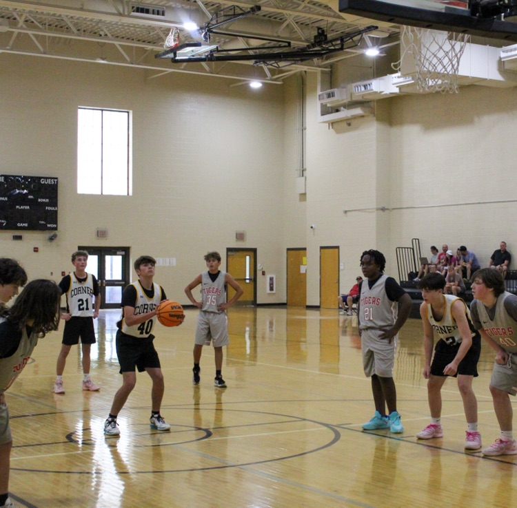A basketball player prepares to shoot a free throw during a game  