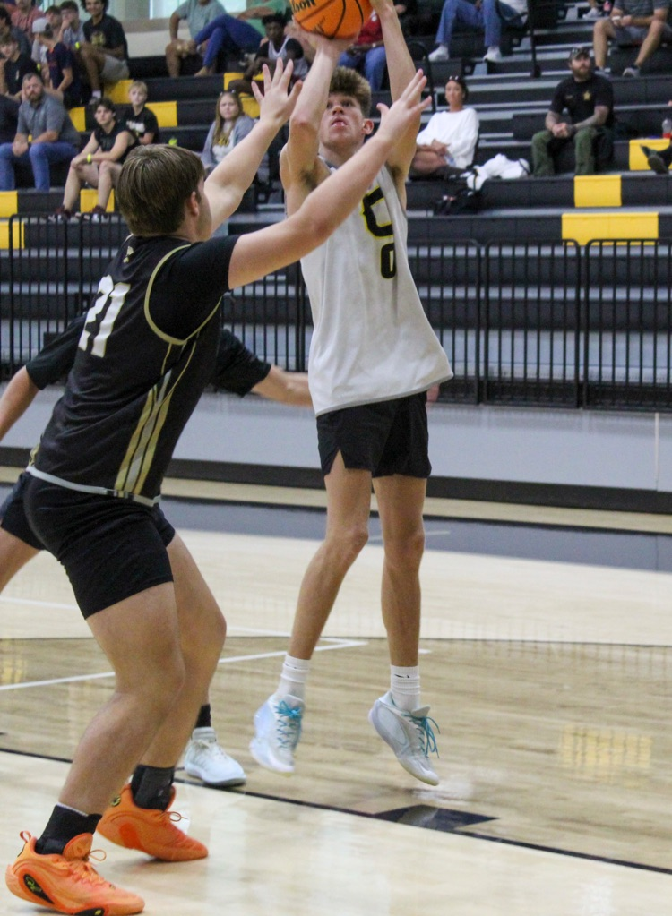 A basketball player shoots the ball during a game  