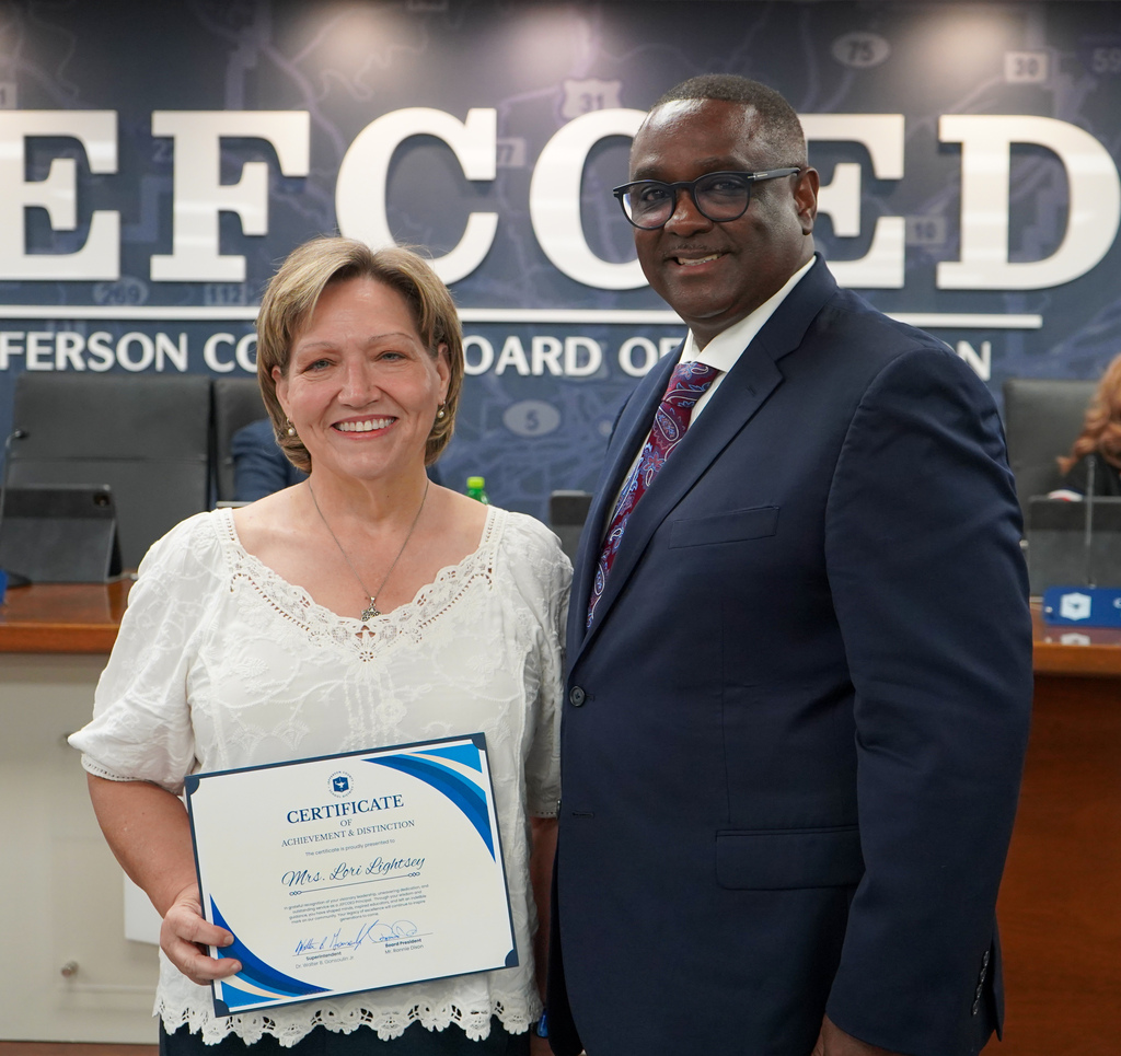 Retired JCIB principal Ms. Lori Lightsey and JEFCOED Superintendent Dr. Walter Gonsoulin pose for a photo inside the JEFCOED board room.
