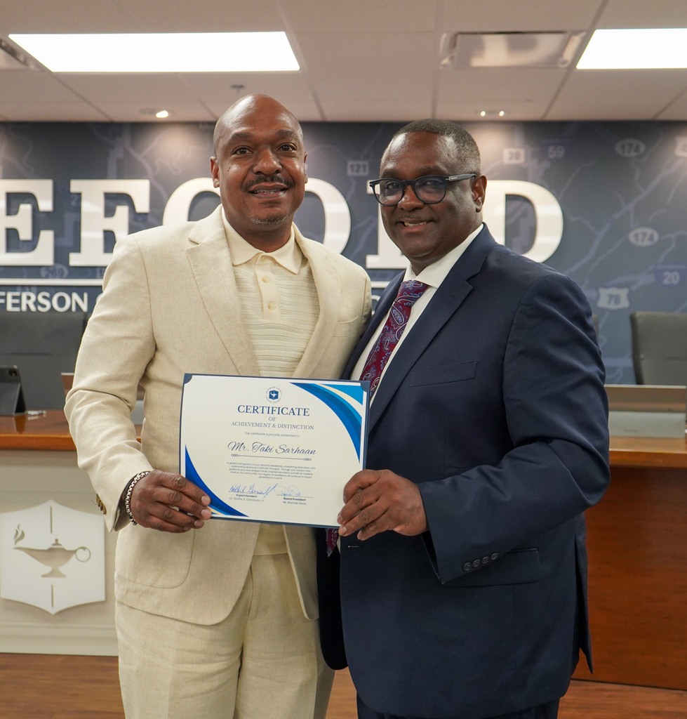 Retired Shades Valley High School principal Mr. Taki Sarhaan and JEFCOED Superintendent Dr. Walter Gonsoulin smile for a photo inside the JEFCOED board room.
