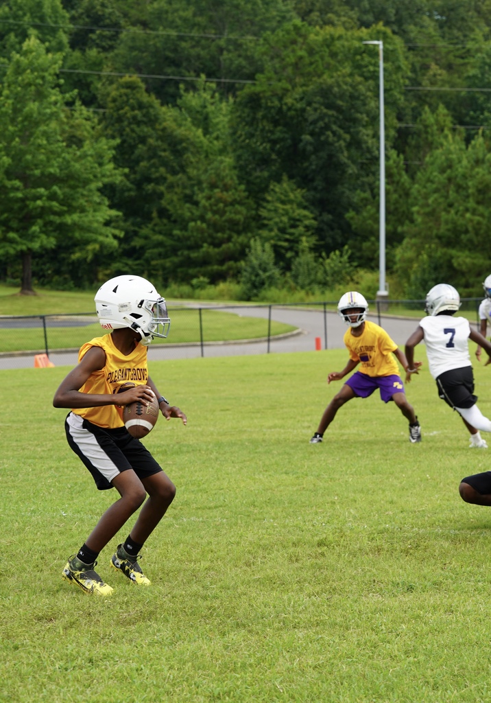 A Pleasant Grove Middle School football player prepares to throw the ball during a game.