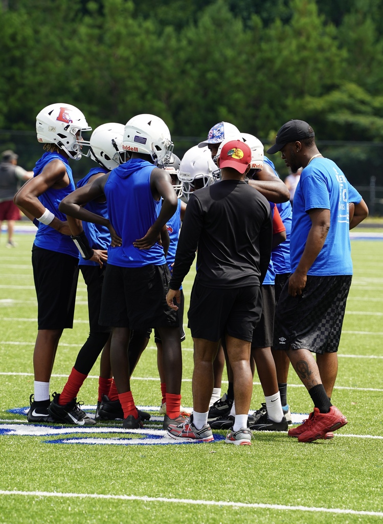 Erwin Middle School football players stand in a huddle during a game.