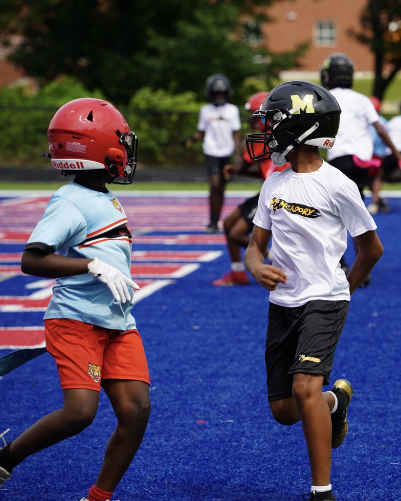 A McAdory Middle School football player guards a player on the opposing team during a game.