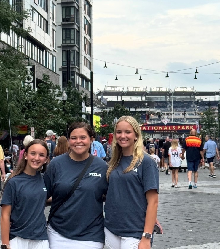 three people stand in FCCLA tshirts in front of Nationals Park