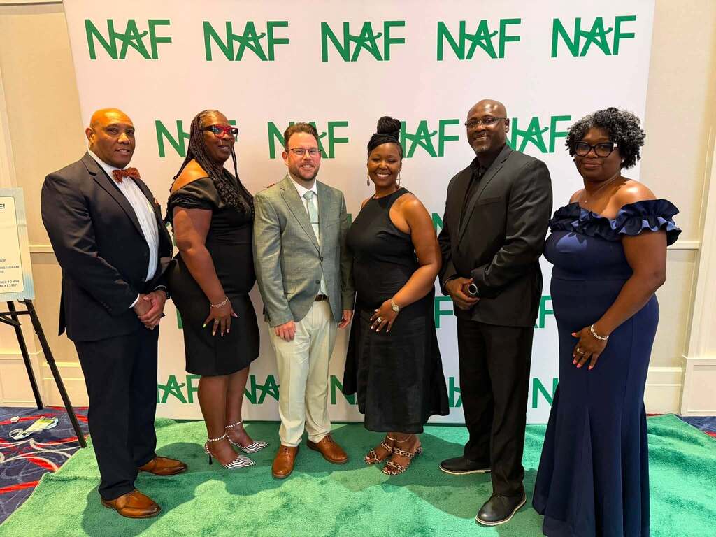 JEFCOED finance instructors and CTE employees pose for a photo while wearing formal wear at the NAF conference.