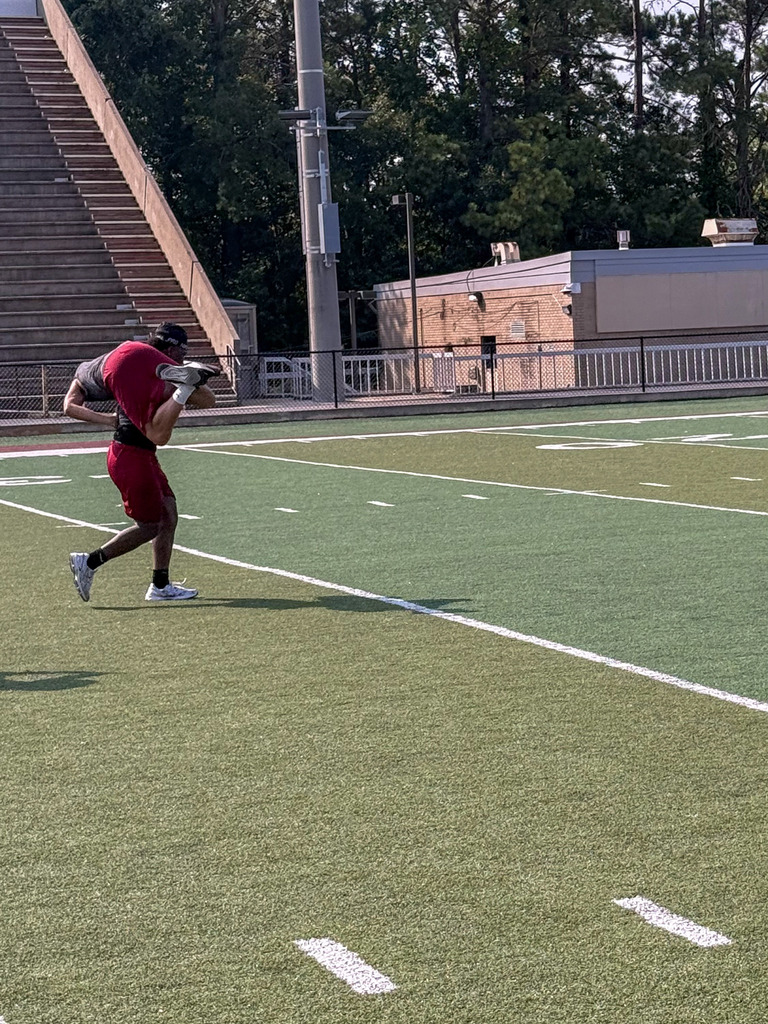 A Pinson Valley football player carries a fellow player across the football field.