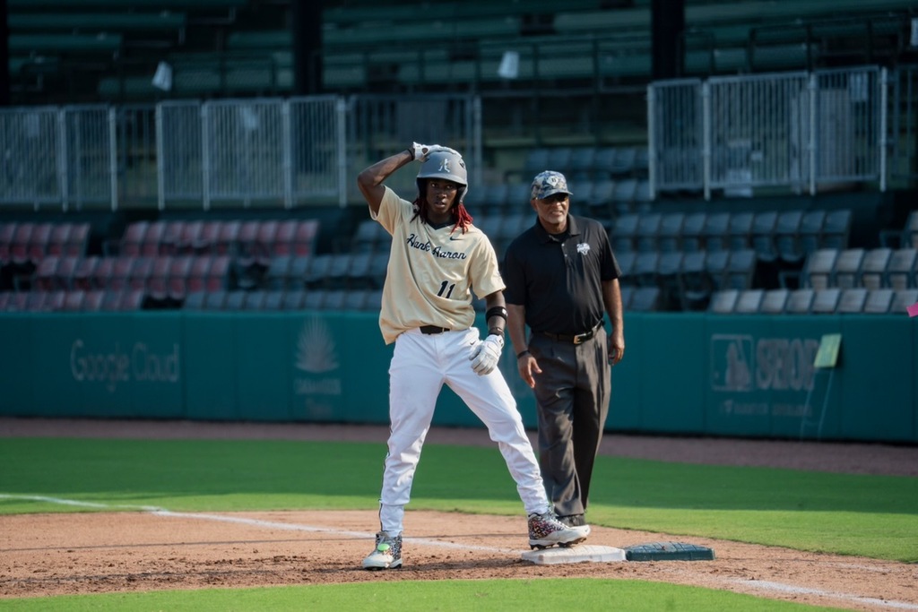 A baseball player stands on first base while playing in the Hank Aaron 44 game at Rickwood Field.