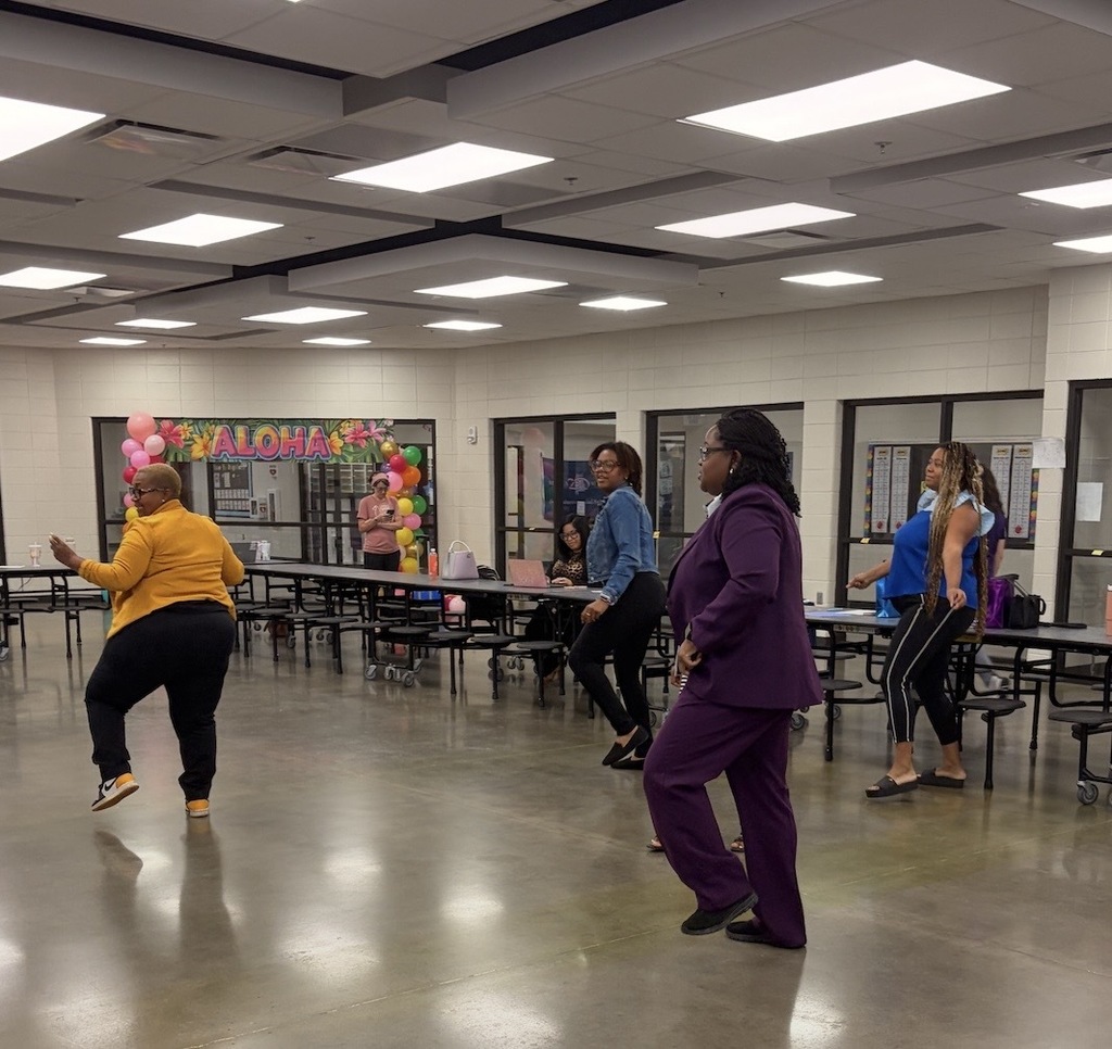 Four teachers "shaking off the nerves" doing a dance