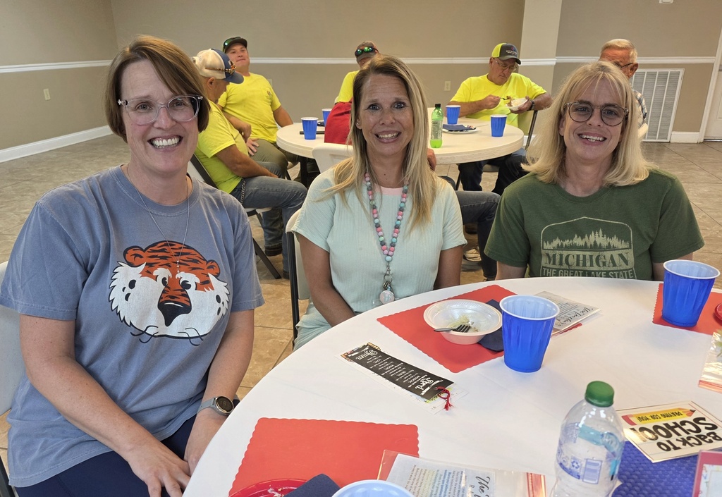 Special education teacher, kindergarten teacher, and secretary sitting at a table