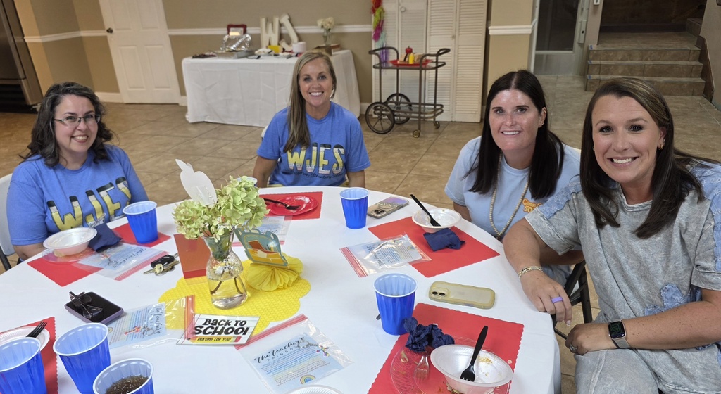 Reading coach, school nurse, librarian, and PE teacher sitting at a table