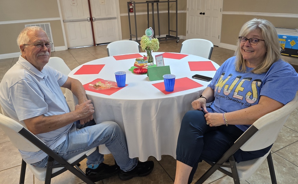 Art teacher and principal sitting at a table