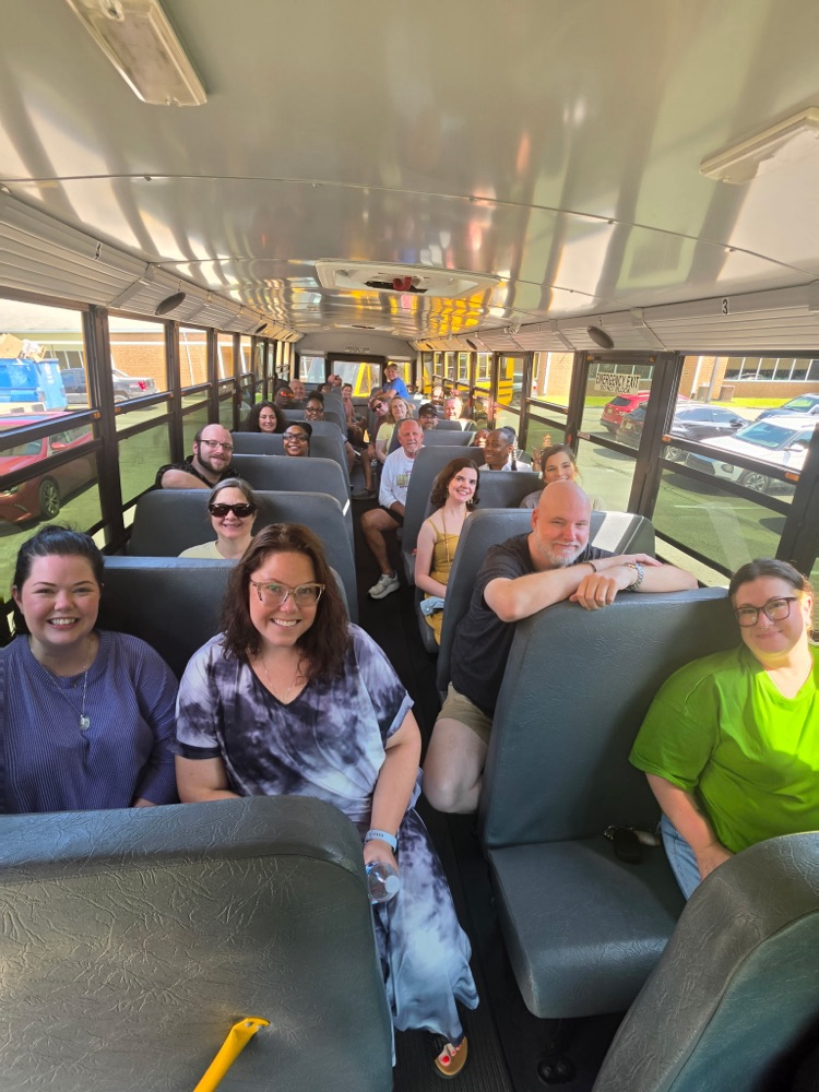 group shot of faculty in bus
