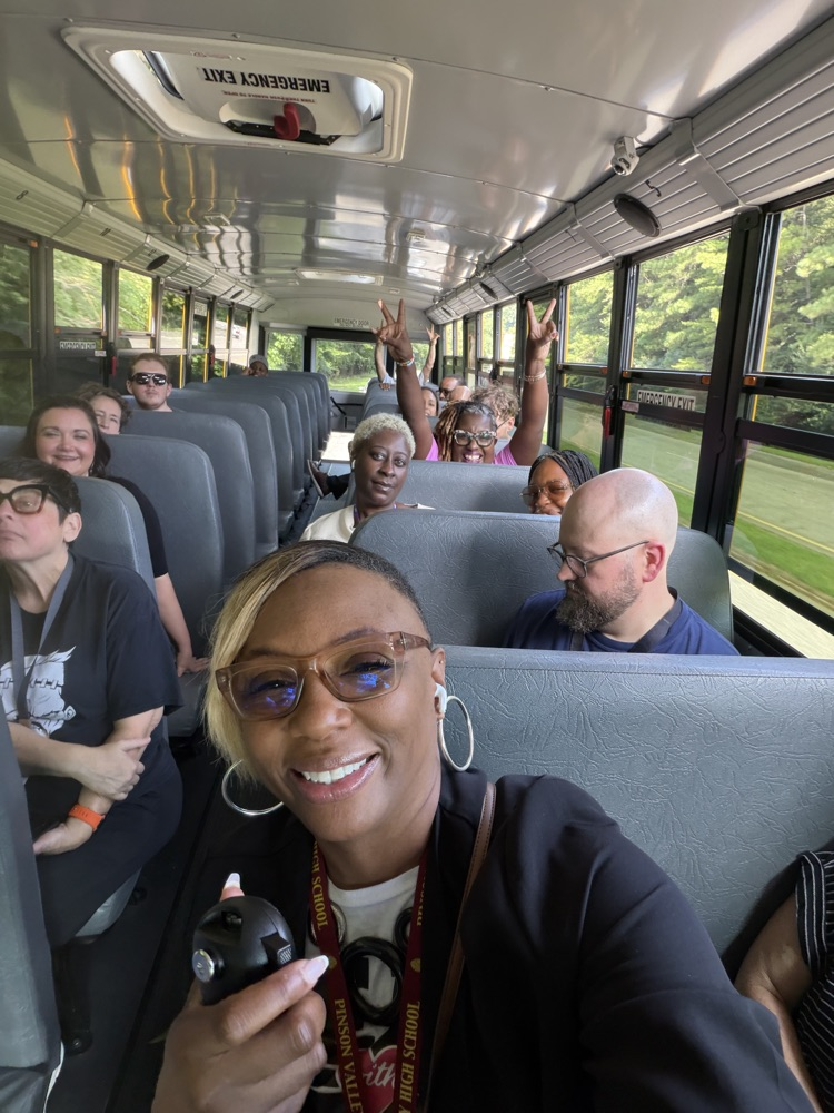 group shot of teachers and staff in a bus