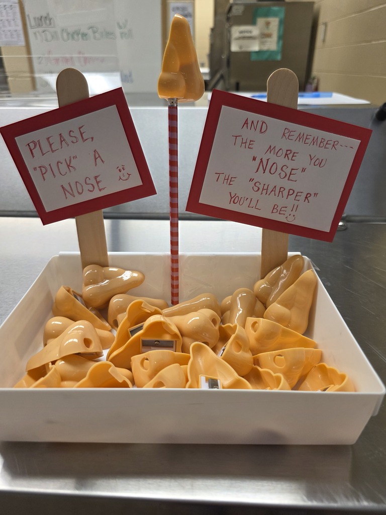 A sign that says "Please Pick a Nose" and it box contains nose shaped pencil sharpeners