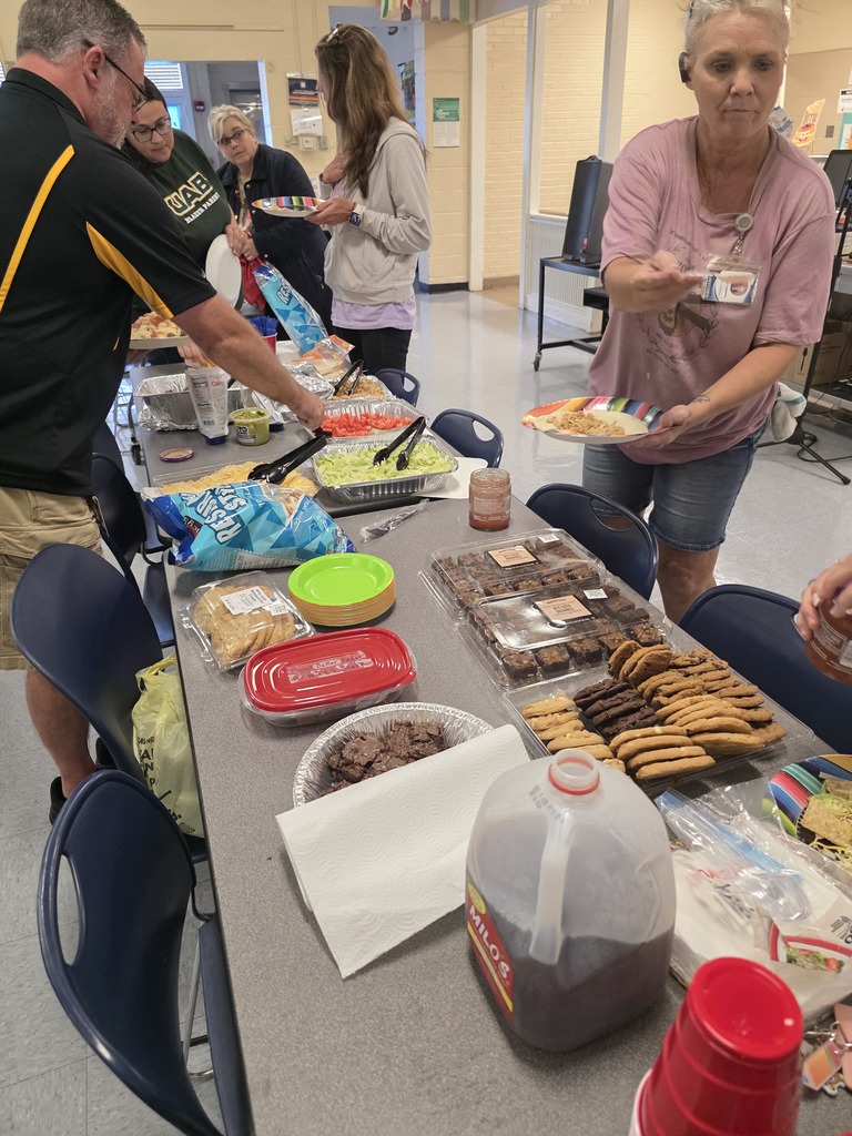 More faculty and staff fixing their plates of food