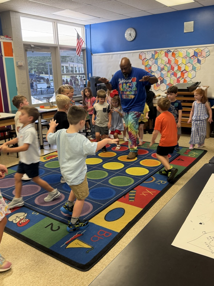 Art teacher moving with younger students