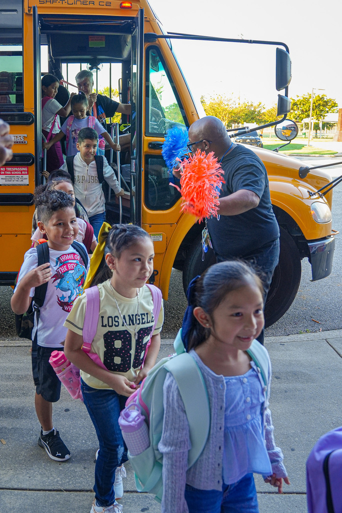 Students get off the bus at Fultondale Elementary School on the first day of the school year.