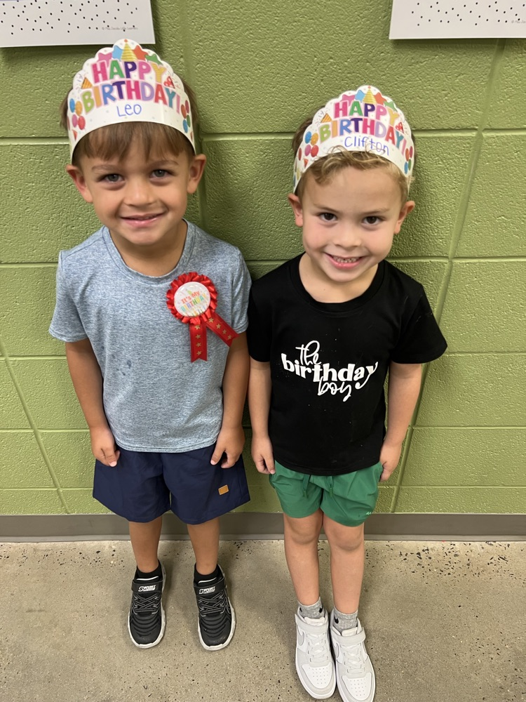 two boys with birthday hats 