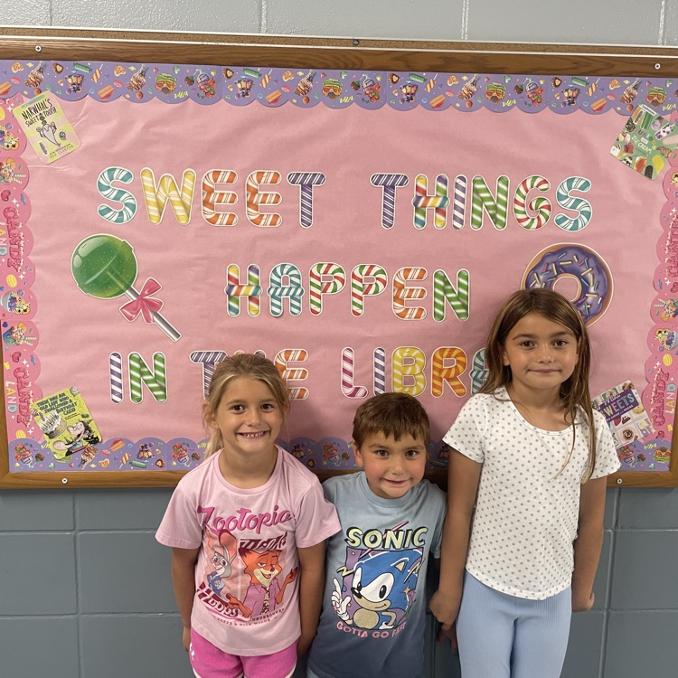 three girls in front of library 