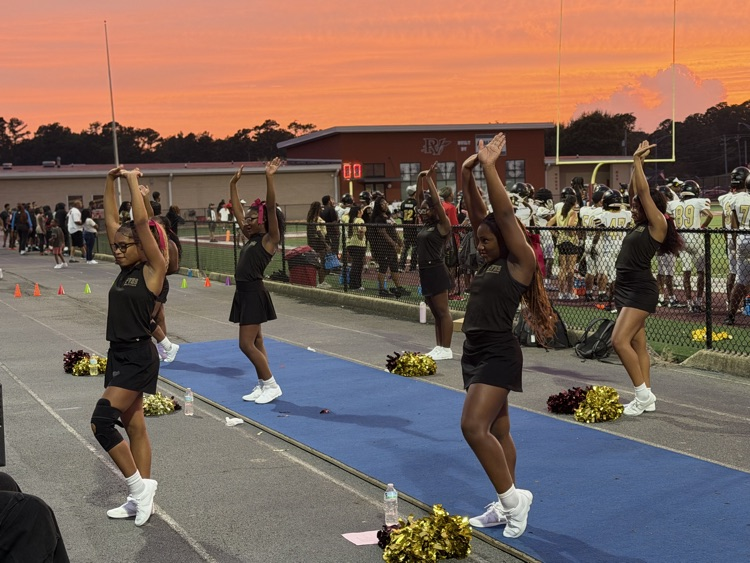 the cheer team cheers from the track