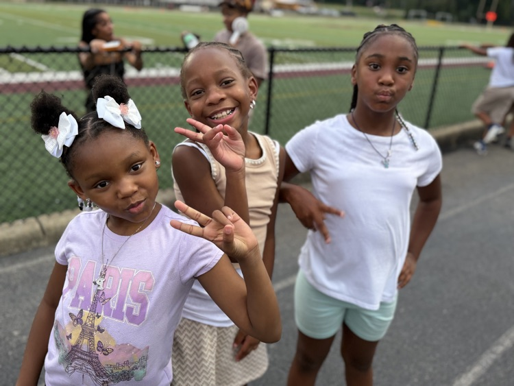 young pinson kids pose for a photo on the track by the field