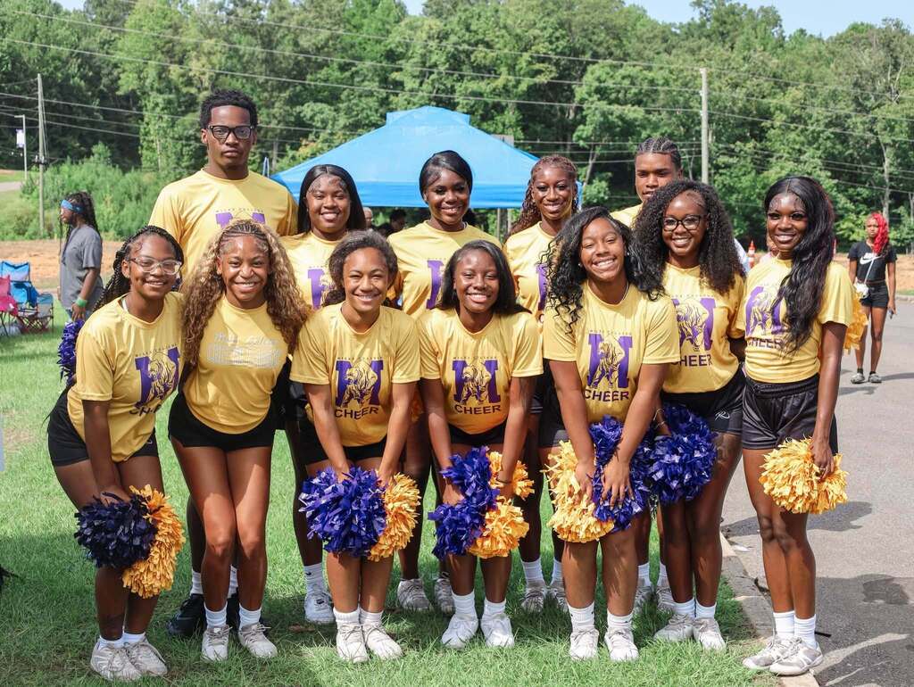 Miles College cheerleaders stand outdoors and smile for a photo.