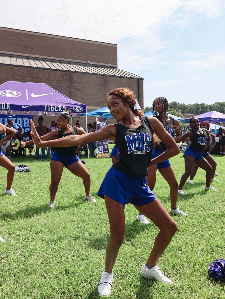 Minor High School cheerleaders perform outdoors.