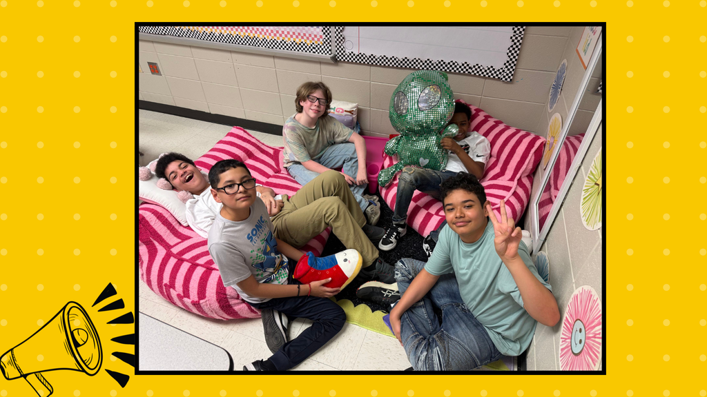 There are 5 boys relaxing a posing at the teacher's relaxation area.