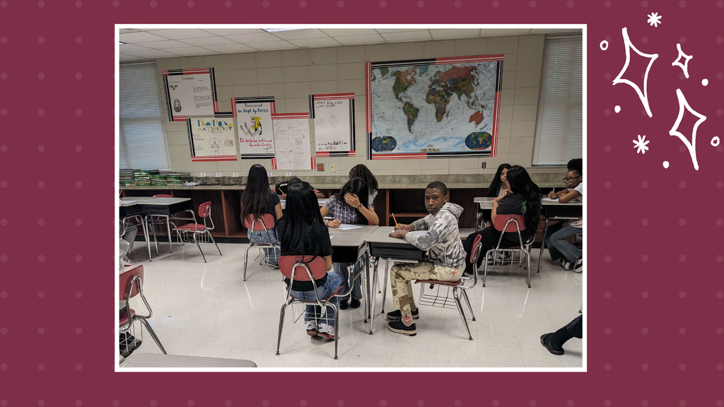 Students in groups of 4 working on a history assignment.