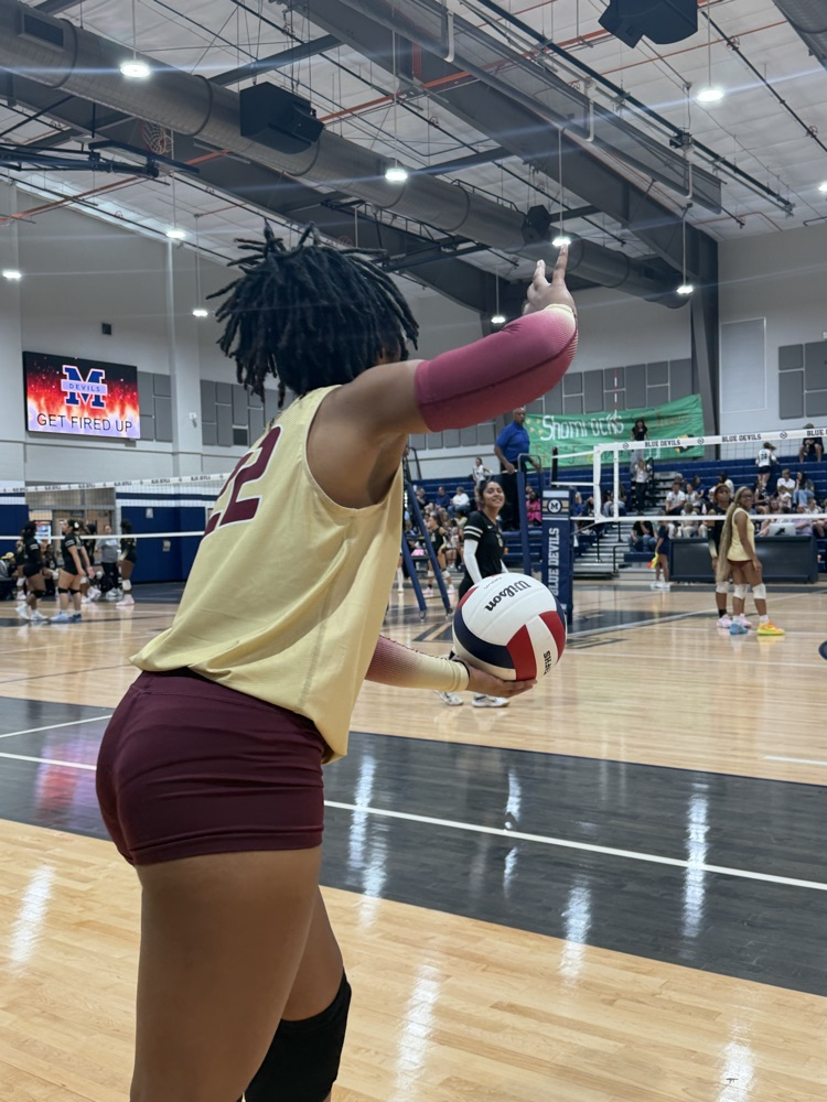 a volleyball player lines up a serve