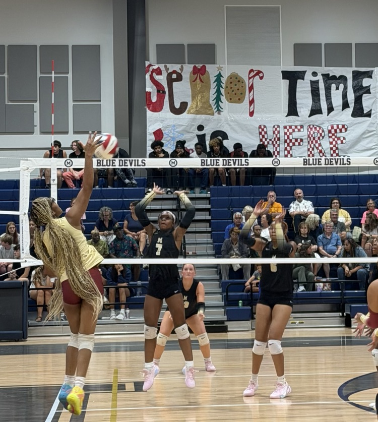 players block the ball before it passes over the net