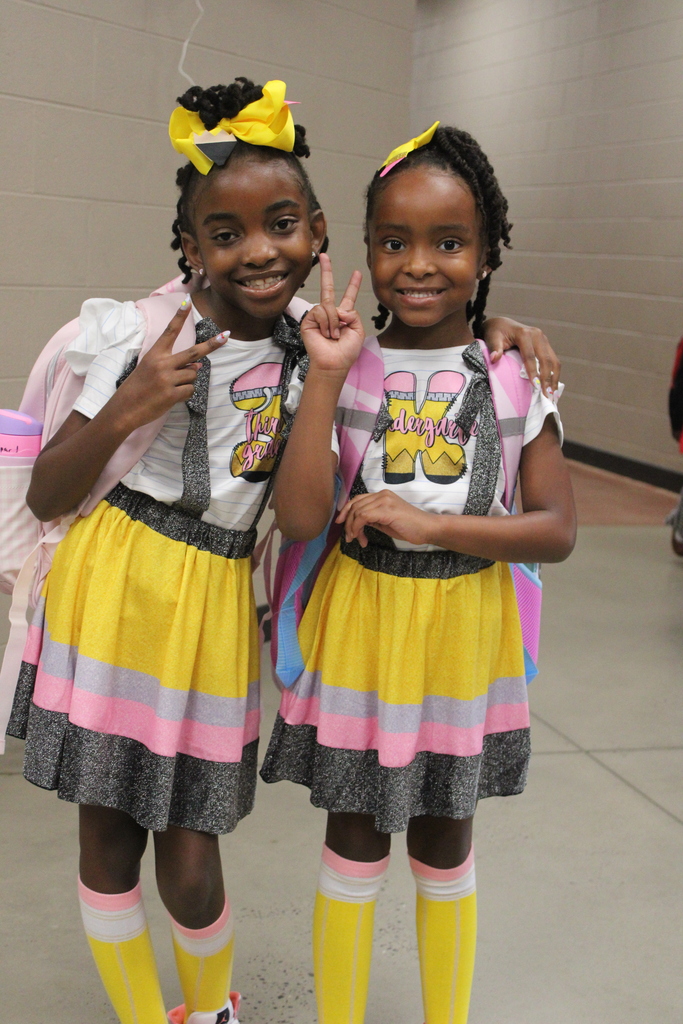 2 sisters wearing matching pencil dresses