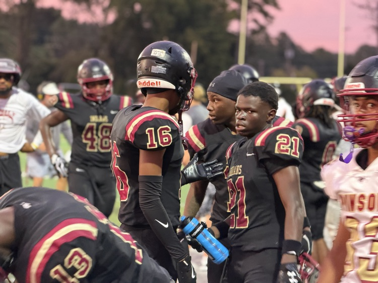 football players walk onto the field