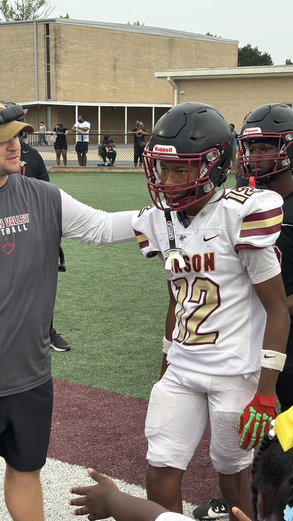 a coach encourages a football player