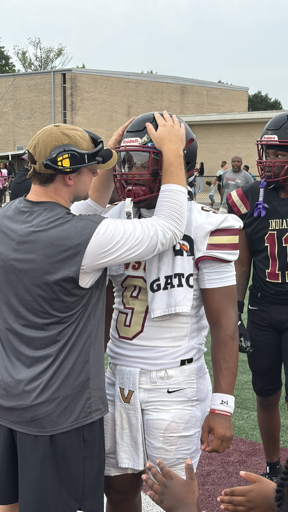 a coach encourages a football player