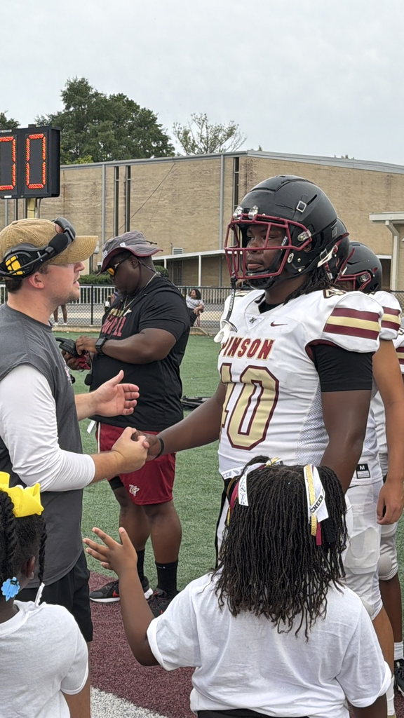 a coach encourages a football player